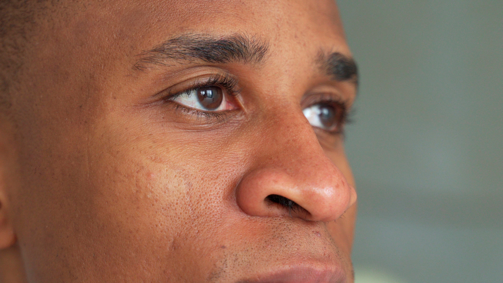 Close-up,Of,A,Black,Man's,Eyes.,Eyes,Of,A,Thoughtful | Look Natural Micropigmentation Clinic Close-up side view of a man with natural dark eyebrows.