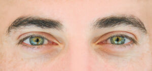 Close-up of male eyes with thick, well-shaped eyebrows.