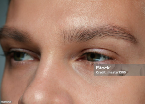 Close-up of man’s face focusing on natural eyebrow shape.
