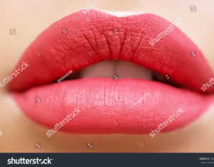 Close-up of soft matte pink lips after semi-permanent makeup.
