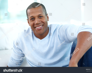Smiling man with natural dark lip tone before treatment.